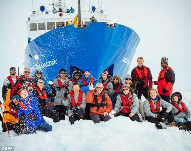 Smile: The crew of 48 passengers and 26 researchers pose for a holiday photograph in the depths of Antarctica